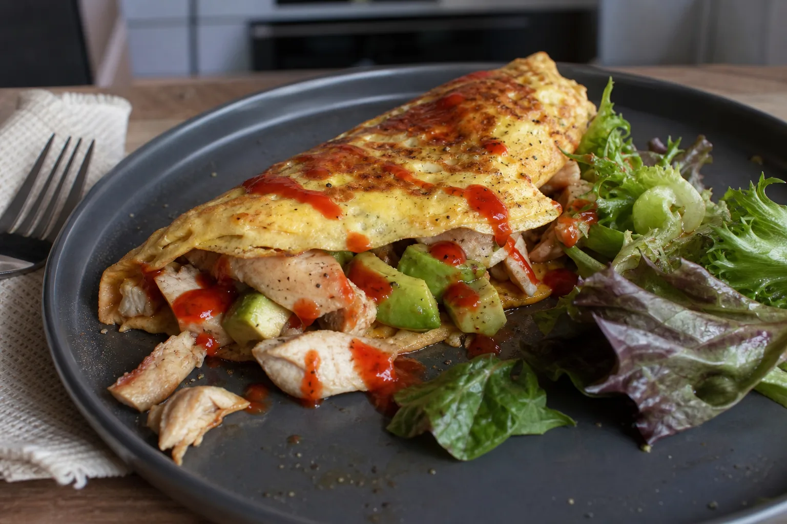 Asian-style protein omelette with spicy avocado, chicken breast and chilli sauce